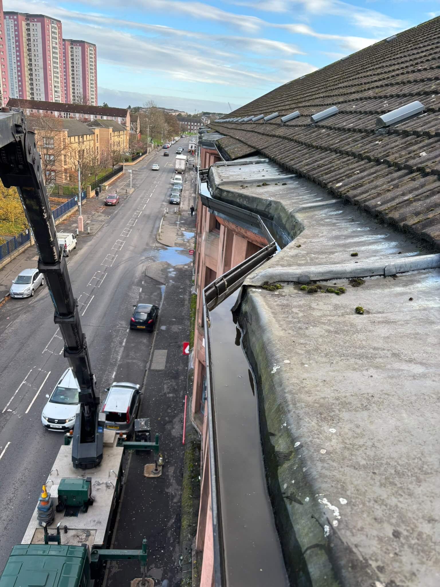 Operated truck-mounted cherry picker providing high-reach gutter cleaning and roofline access in Glasgow