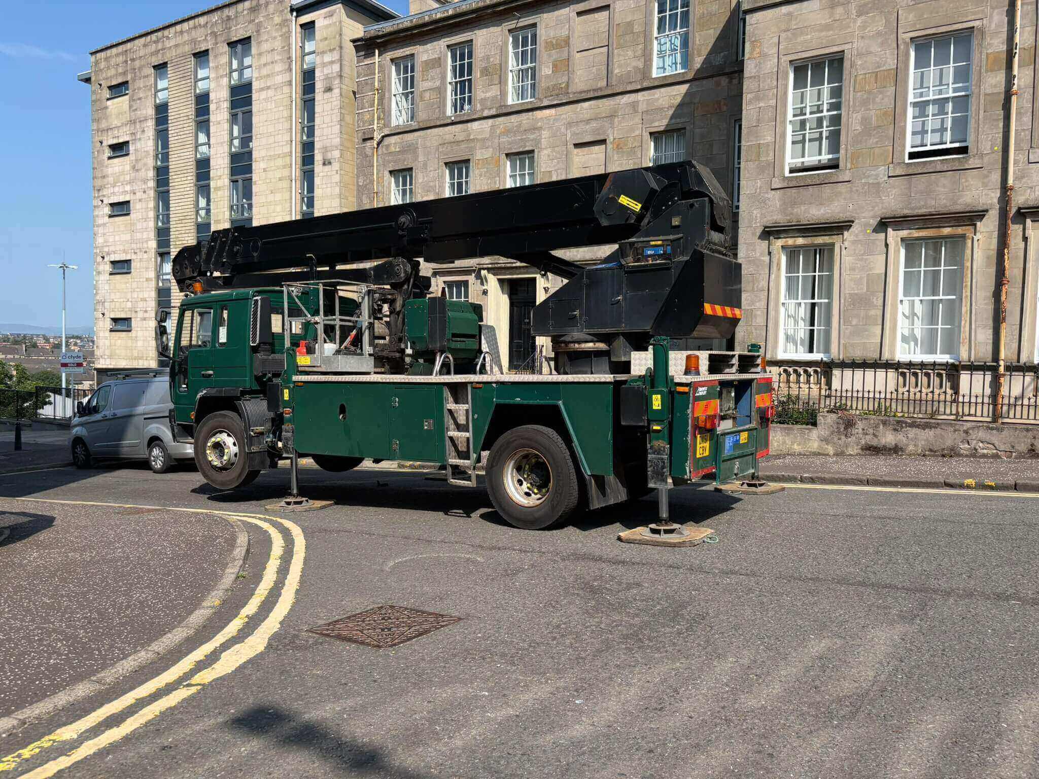 Truck mounted MEWP platform hire rig with outriggers set up for high access work